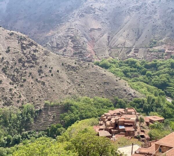 Walking through Azzaden Valley red soil landscapes – Berber Villages Trek 6 Days